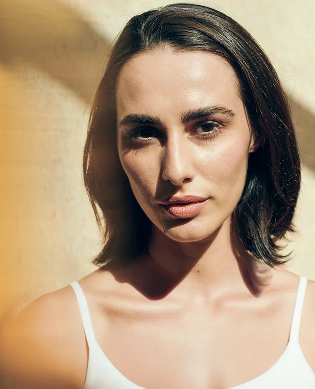 A front-facing portrait of a woman with clear, radiant skin, showcasing the skin-resurfacing benefits of CO2 laser ablation treatments.