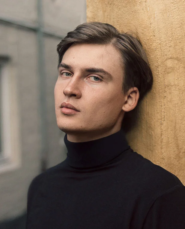 A profile portrait of a man with clean, well-defined features, representing the natural appearance achieved after earlobe reconstruction surgery.