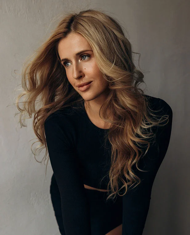 A portrait of a woman with vibrant skin and healthy hair, showcasing the holistic aesthetic benefits of microneedling with Platelet-Rich Plasma (PRP).