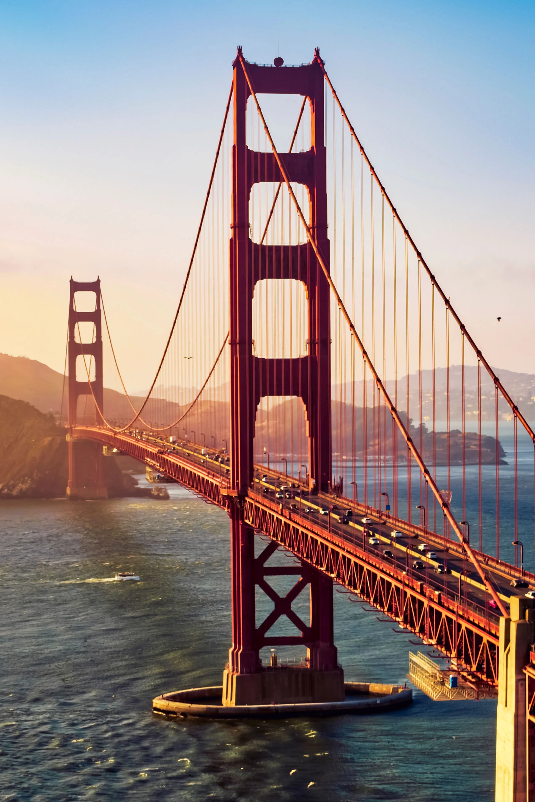 A vertical shot of the Golden Gate Bridge at sunset, symbolizing the beautiful recovery environment for patients traveling to the clinic.