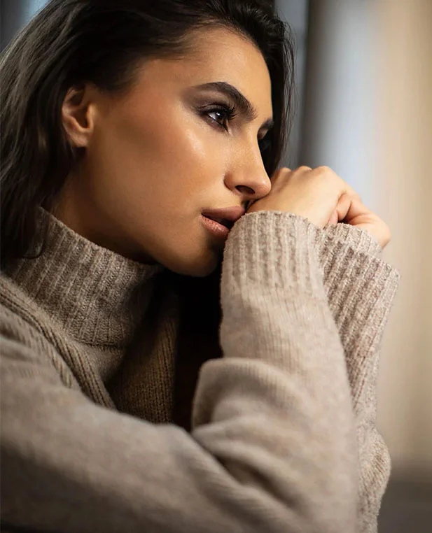 A profile view of a woman with a balanced and harmonious nasal shape, illustrating the aesthetic outcome of a surgical rhinoplasty.